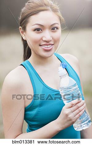 Asian woman drinking water View Large Photo Image Stock Image - Asian woman drinking water. Fotosearch