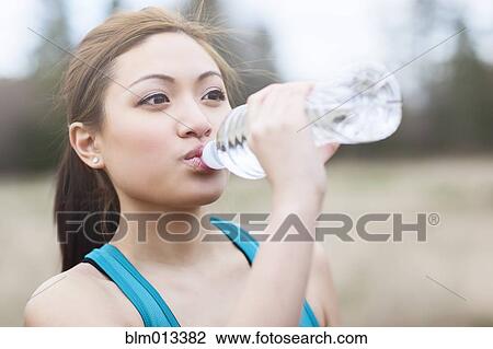 Asian woman drinking water View Large Photo Image Stock Image - Asian woman drinking water. Fotosearch