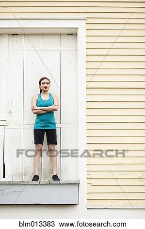 Asian woman in sportswear standing on loading dock View Large Photo Image Stock Image - Asian woman in sportswear standing on loading dock. Fotosearch