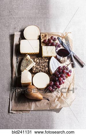 Stock Image - Assorted cheese and fruit with wine. Fotosearch