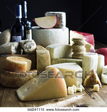 Assorted cheeses and bottles of wine View Large Photo Image Stock Photography - Assorted cheeses and bottles of wine. Fotosearch