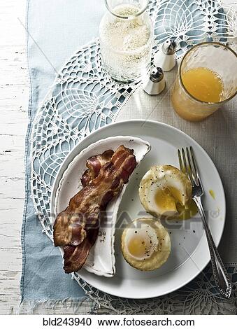 "Baked eggs with bacon, juice and champagne" View Large Photo Image Stock Image - "Baked eggs with bacon, juice and champagne". Fotosearch