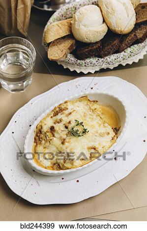 Stock Photo - Baked lasagna and bread. Fotosearch