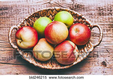 Basket of apples on wooden table View Large Photo Image Stock Photography - Basket of apples on wooden table. Fotosearch