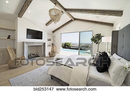 Bed and fireplace in luxury bedroom View Large Photo Image Stock Photo - Bed and fireplace in luxury bedroom. Fotosearch