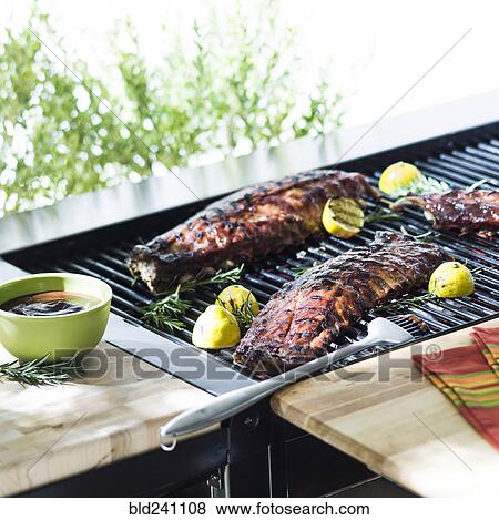 Beef ribs cooking on barbecue grille View Large Photo Image Stock Photo - Beef ribs cooking on barbecue grille. Fotosearch