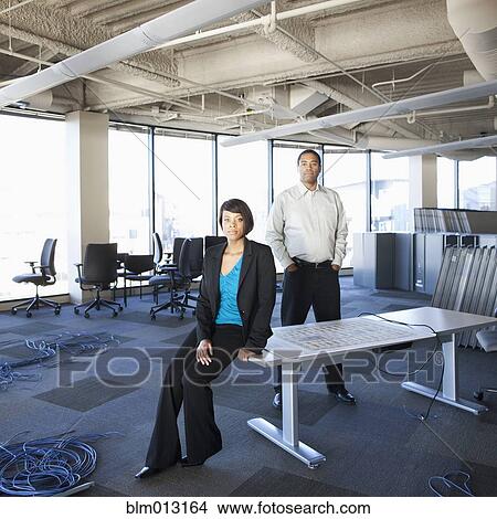Picture - Black business people moving into new office. Fotosearch