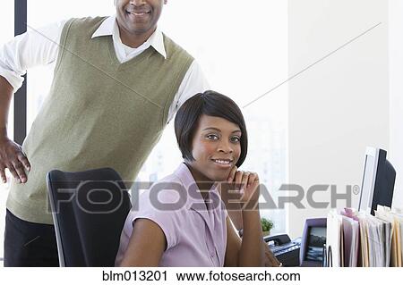 Stock Image - Black business people working together in office. Fotosearch