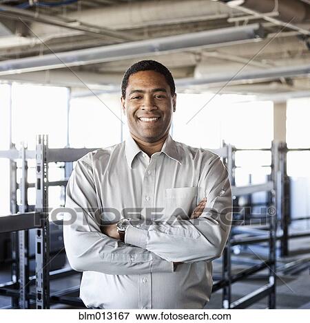 Stock Photo - Black businessman standing in new office. Fotosearch