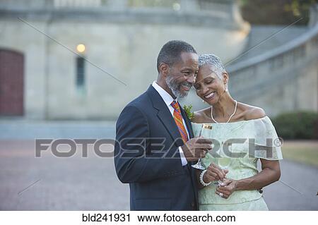 Stock Image - Black couple drinking champagne. Fotosearch