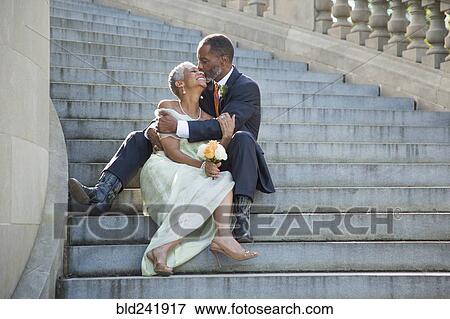 Stock Photo - Black couple kissing on stone staircase. Fotosearch