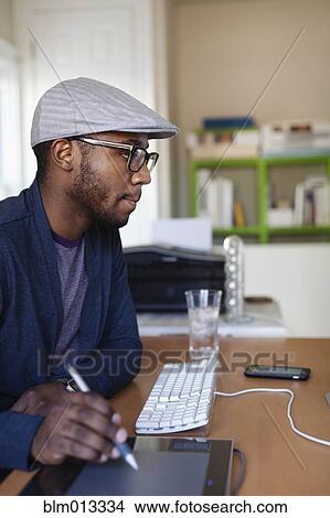Black designer working at desk View Large Photo Image Picture - Black designer working at desk. Fotosearch