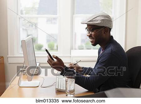 Black designer working at desk View Large Photo Image Stock Photography - Black designer working at desk. Fotosearch