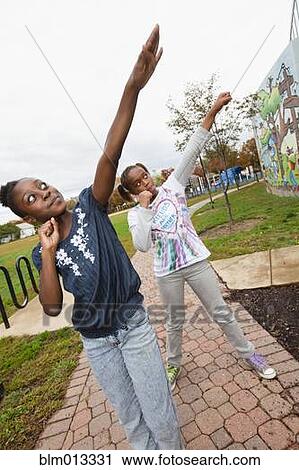 Black girls practicing cheer leading View Large Photo Image Stock Image - Black girls practicing cheer leading. Fotosearch