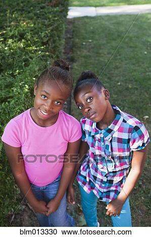 Stock Image - Black girls standing together. Fotosearch