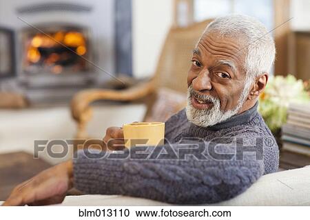 Stock Image - Black man drinking coffee. Fotosearch
