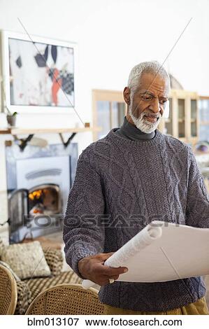 Black man looking at blueprints View Large Photo Image Stock Photo - Black man looking at blueprints. Fotosearch