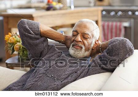 Stock Image - Black man taking a nap. Fotosearch
