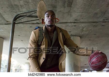 Black man wearing backpack playing basketball under overpass View Large Photo Image Stock Photography - Black man wearing backpack playing basketball under overpass. Fotosearch