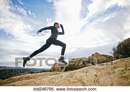 Black woman running on rock formation View Large Photo Image Stock Photography - Black woman running on rock formation. Fotosearch