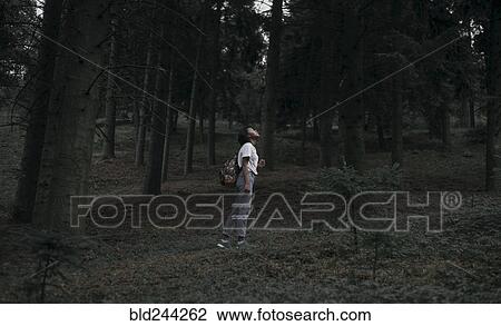 Black woman standing in forest looking up View Large Photo Image Stock Image - Black woman standing in forest looking up. Fotosearch