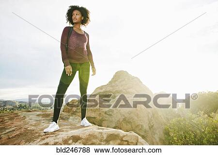 Black woman standing on rock formation View Large Photo Image Stock Photo - Black woman standing on rock formation. Fotosearch