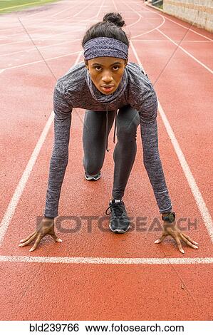 Black woman waiting at starting line on track View Large Photo Image Stock Photograph - Black woman waiting at starting line on track. Fotosearch