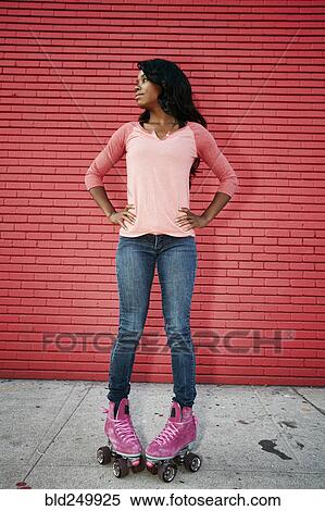 Black woman wearing roller skates on sidewalk View Large Photo Image Stock Photography - Black woman wearing roller skates on sidewalk. Fotosearch