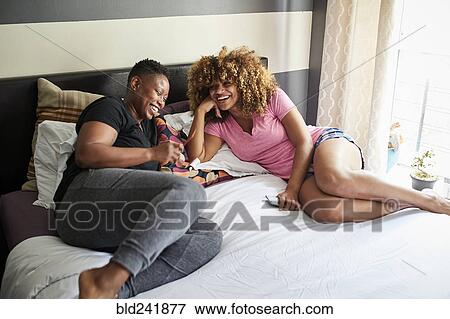 Black women laughing on bed View Large Photo Image Stock Photo - Black women laughing on bed. Fotosearch