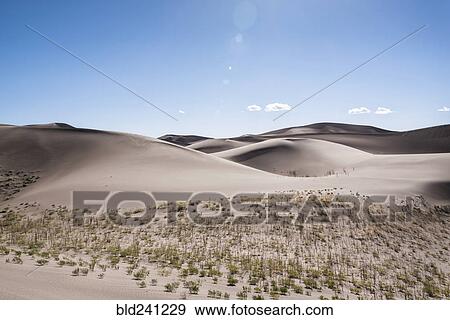 Blue sky over sand dunes View Large Photo Image Stock Photo - Blue sky over sand dunes. Fotosearch