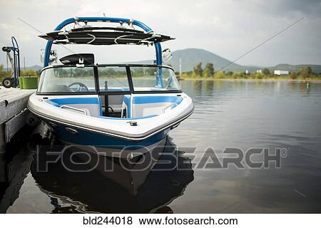 Stock Photo - Boat at dock in river. Fotosearch
