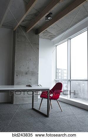 Book on table near red chair View Large Photo Image Stock Photography - Book on table near red chair. Fotosearch