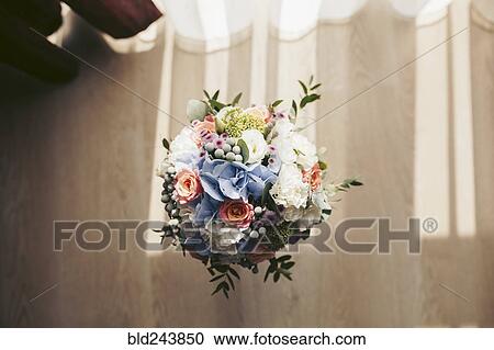 Stock Image - Bouquet of flowers in vase on floor. Fotosearch
