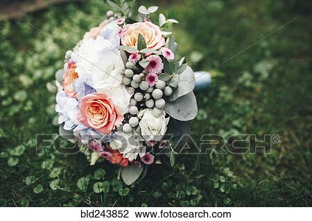 Bouquet of flowers laying in grass View Large Photo Image Stock Image - Bouquet of flowers laying in grass. Fotosearch