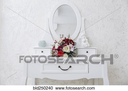 Stock Image - Bouquet of flowers on white vanity. Fotosearch