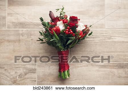 Stock Image - Bouquet of flowers on wooden floor. Fotosearch