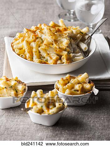 Stock Image - Bowl and cups of macaroni and cheese. Fotosearch