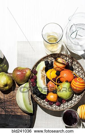 Stock Photograph - Bowl of fruit with wine and water. Fotosearch