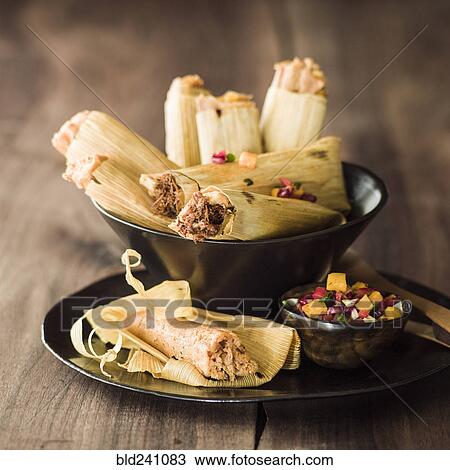 Stock Image - Bowl of tamales with salsa. Fotosearch