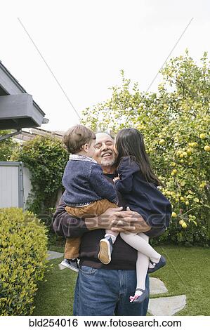 Boy and girl kissing grandfather View Large Photo Image Stock Photograph - Boy and girl kissing grandfather. Fotosearch
