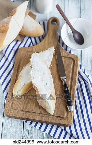 Bread with butter on cutting board View Large Photo Image Stock Photograph - Bread with butter on cutting board. Fotosearch