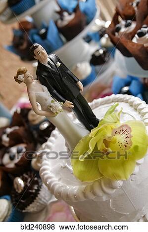 Bride and groom toppers on wedding cake View Large Photo Image Stock Photo - Bride and groom toppers on wedding cake. Fotosearch