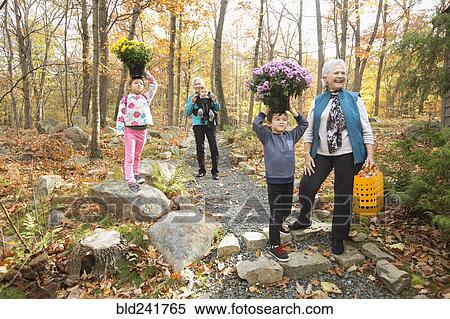 Brother and sister balancing flowers on heads near grandmothers View Large Photo Image Stock Photography - Brother and sister balancing flowers on heads near grandmothers. Fotosearch