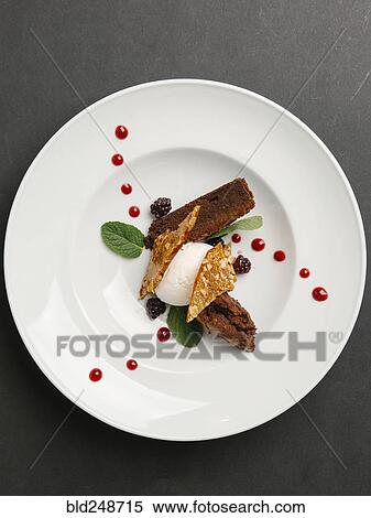 Stock Photography - Brownie with ice cream and caramel. Fotosearch