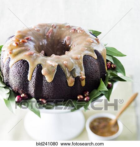 Stock Image - Bundt cake with berries and nuts. Fotosearch