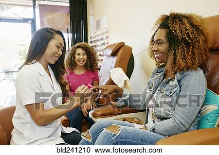 Business owner assisting customer in nail salon View Large Photo Image Stock Image - Business owner assisting customer in nail salon. Fotosearch