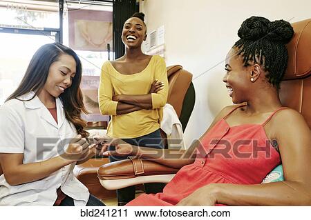 Business owner assisting customer in nail salon View Large Photo Image Stock Image - Business owner assisting customer in nail salon. Fotosearch