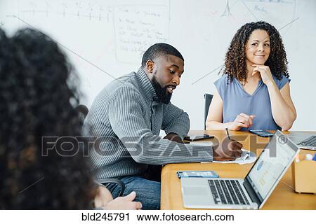 Stock Image - Business people in meeting. Fotosearch