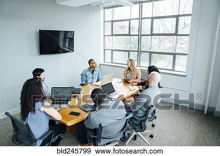 Stock Photo - Business people in meeting. Fotosearch