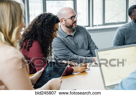 Stock Photo - Business people in meeting. Fotosearch